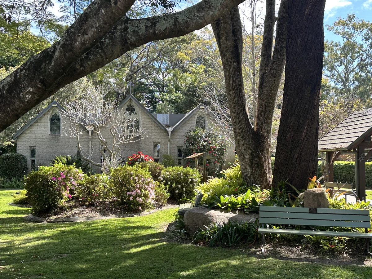 Garden bench and mature trees outside The Abbey Church.