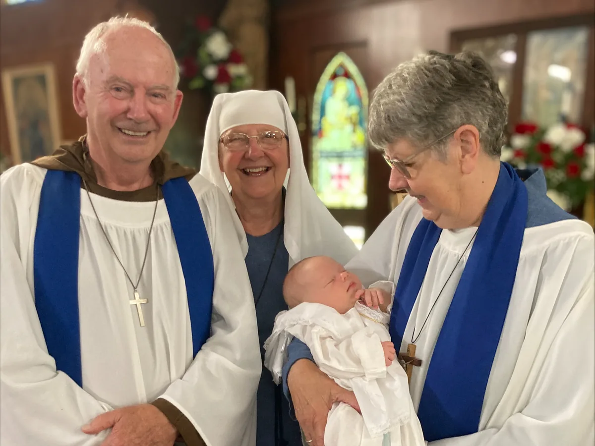 Infant baptism celebration inside The Abbey Church
