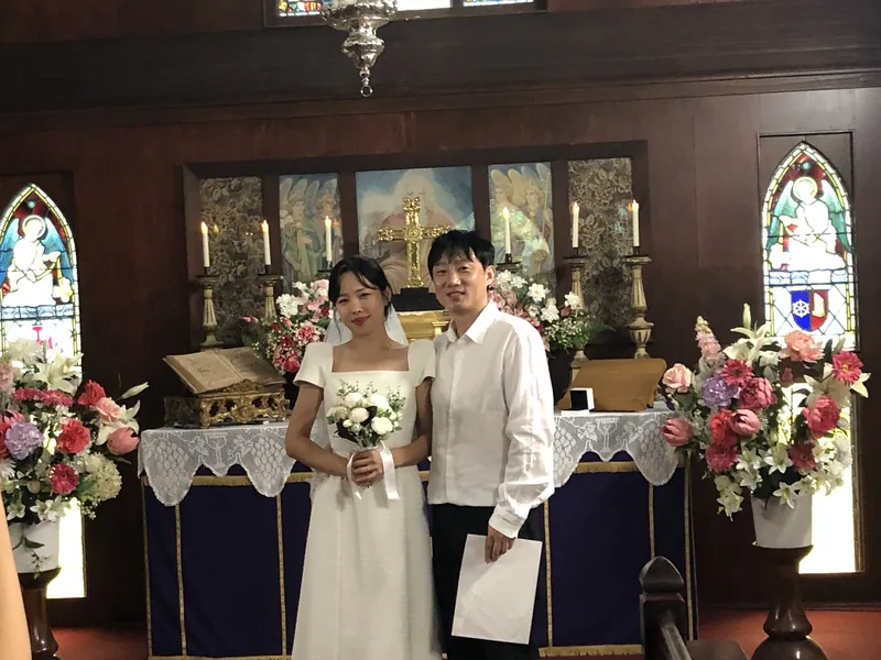 Newly married couple at the altar after a chapel wedding at The Abbey Church.